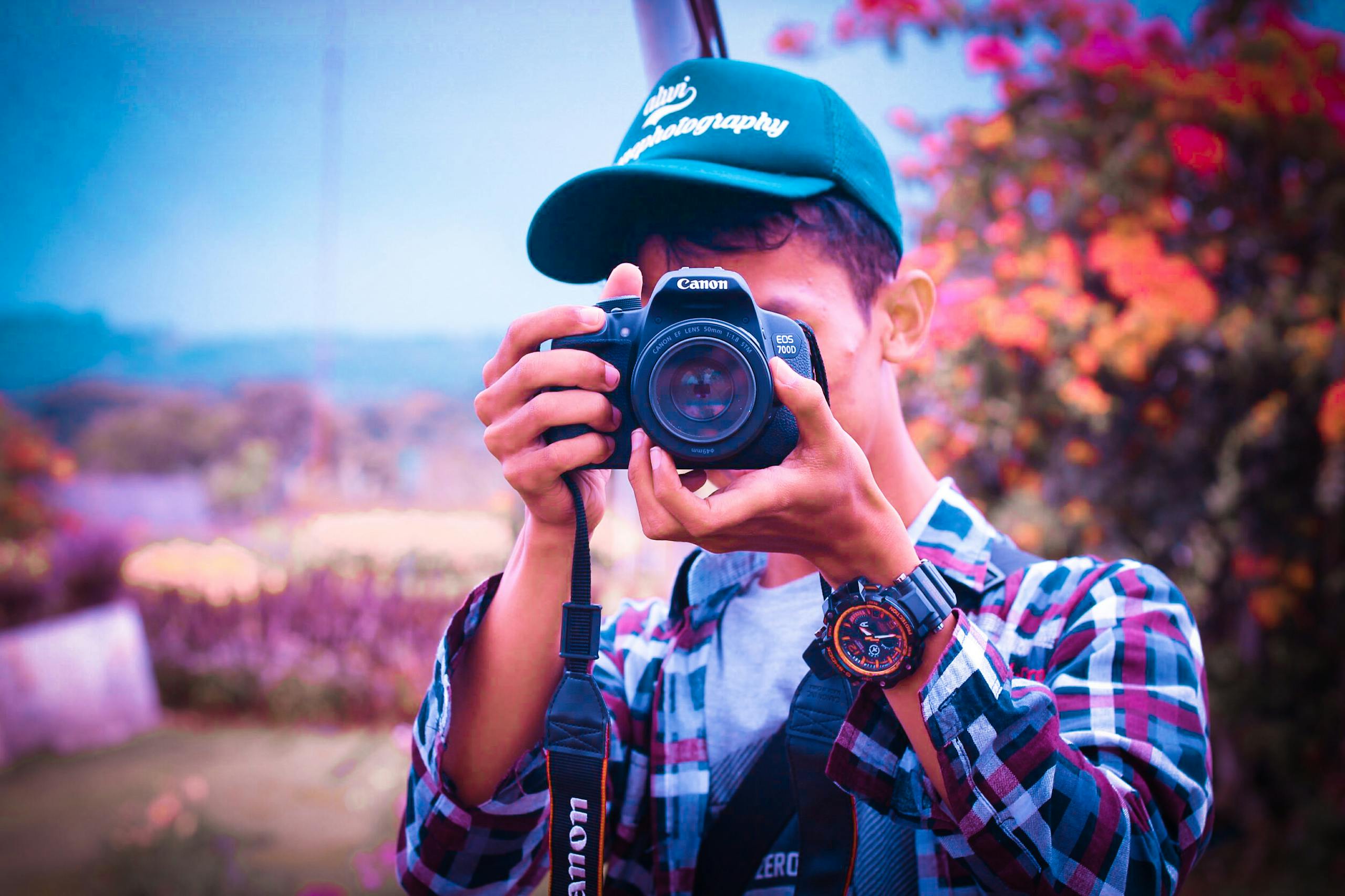 Shallow Focus Photography of a Man Holding Camera